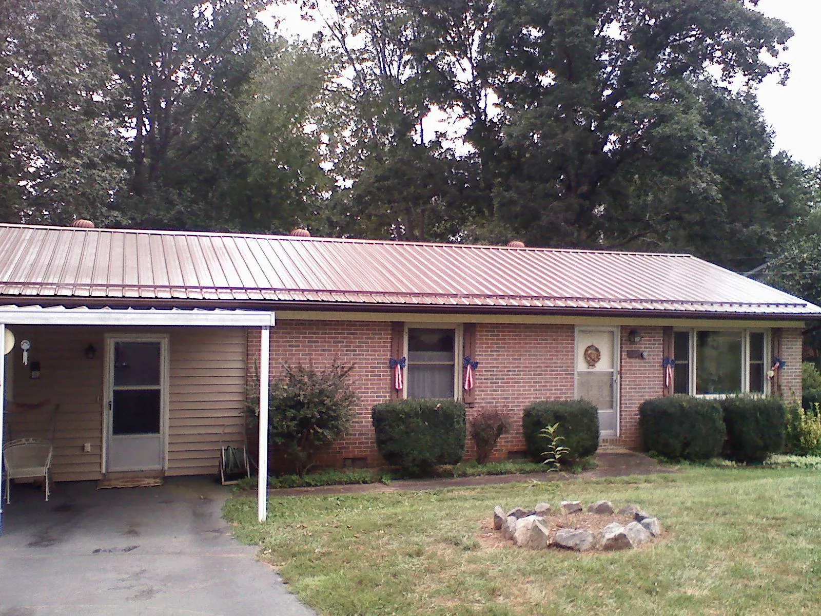 Bronze metal roof and carport on a brick ranch home — Roof Repair work by our crew in Culpeper