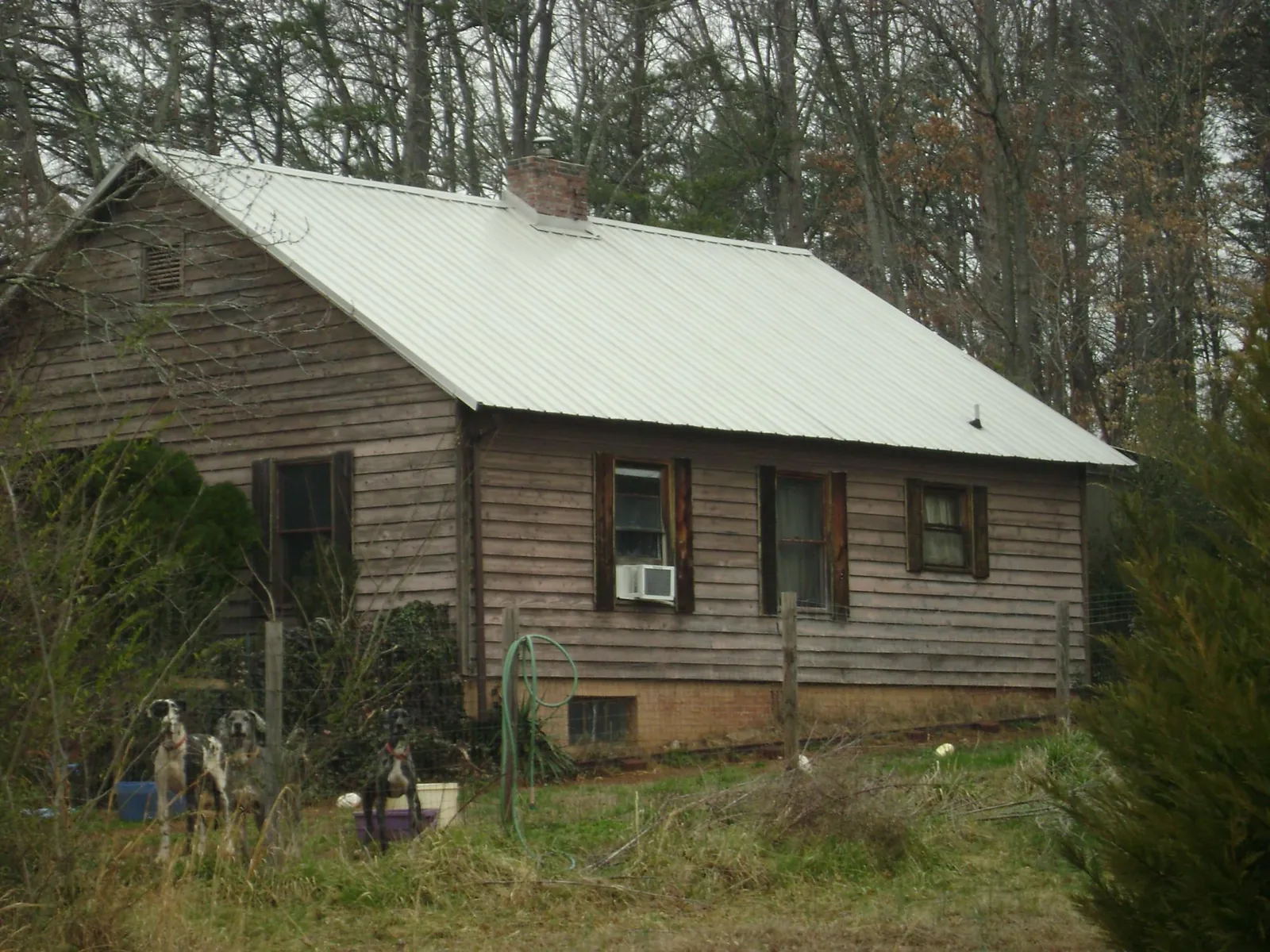 White metal roof on an old wood sided farmhouse, from a Metal Roof Installation job in Culpeper